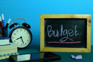 Budget Planning on Background of Working Table with Office Supplies. Business Concept Planning on Blue Background photo