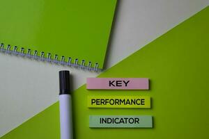 Key Performance Indicator text on top view office desk table of Business workplace and business objects. photo