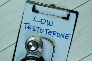 Concept of Low Testoterone write on a paperwork isolated on Wooden Table. photo