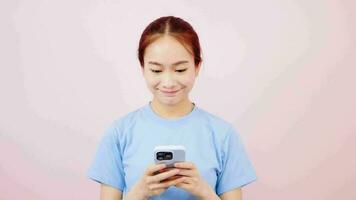 Asian corporate woman in t-shirt looking at smartphone app using mobile video