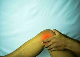 suffering from joint pain with red spot. Hands on leg as hurt from Arthritis. Osteoarthritis knee disease concept photo