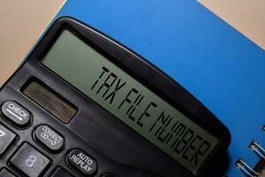 Tax File Number write on the calculator on Office Desk. photo