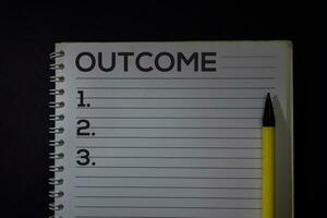 Outcome and Number write on a book isolated on Office Desk. photo