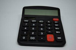 Close up black calculator isolated on white background photo