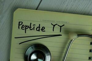 Peptide YY write on a book isolated on office desk. photo