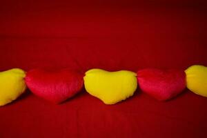 Pillow hearts shape on red background with copy space. Happy Valentine's day photo