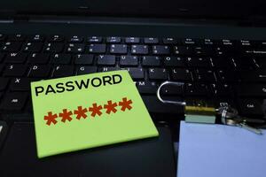 Strong Password on sticky Notes isolated on laptop keyboard background. Security concept photo