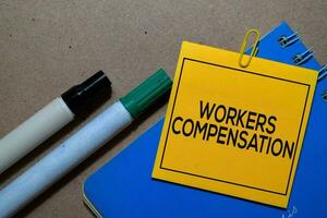 Workers Compensation write on sticky notes isolated on Office Desk photo