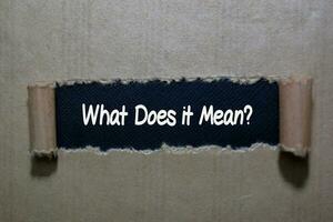 What Does it Mean write on brown torn paper photo