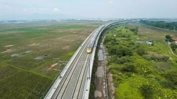 Aerial view of the High speed orange train on the railway station. High Speed Train Jakarta-Bandung. Bandung, Indonesia, November 22, 2022 photo