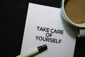 Take Care Of Yourself text on the paper isolated on office desk background photo