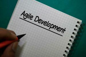 Agile Development write on a book isolated on Office Desk photo