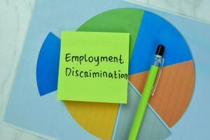 Concept of Employment Discrimination write on sticky notes isolated on Wooden Table. photo