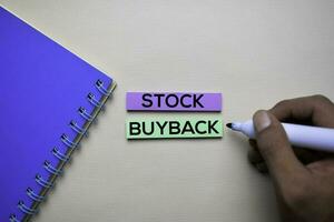 Stock Buyback text on sticky notes with office desk. Stock Market Exchange Concept photo