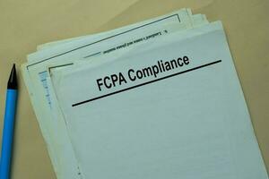 FCPA Compliance write on a paperwork isolated on office desk. photo