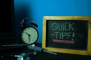 Quick Tips Planning on Background of Working Table with Office Supplies. Medical and Healthcare Concept Planning on Blue Background photo