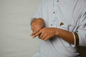 Close up Asian man shows hand gestures it means SAME isolated on white background. American sign language photo