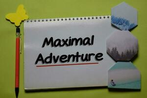 Maximal Adventure write on a book isolated on office desk. photo