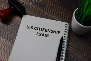 Book about U.S Citizenship Exam isolated on wooden table. photo