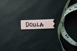 Doula write on sticky notes isolated on office desk. photo