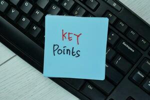 Key Points write on sticky notes isolated on Wooden Table. photo