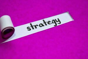 Strategy text, Inspiration, Motivation and business concept on purple torn paper photo