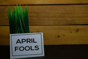 April Fools write on a sticky note isolated on wooden background. photo