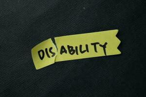 Disability to be Ability write on sticky notes isolated on office desk. photo
