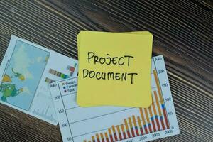 Concept of Project Document write on sticky notes isolated on Wooden Table. photo
