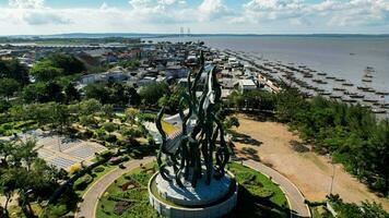 Aerial view of the A giant shark and crocodile statue as a symbol of the city of Surabaya. A landmark or monument as an icon of Surabaya city. East Java, Indonesia, August 28, 2022 photo