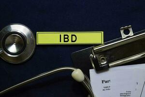 IBD text on sticky notes and stethoscope isolated on office desk. Heathcare medical concept photo