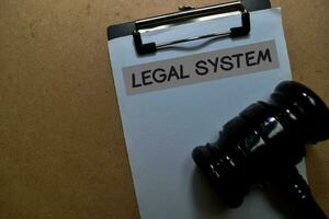 Legal System write on a paperwork with gavel isolated on Office Desk photo