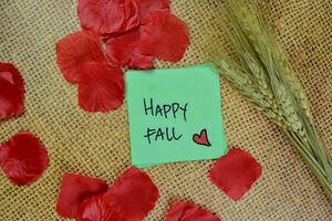 Happy Fall write on sticky notes isolated on Wooden Table. photo