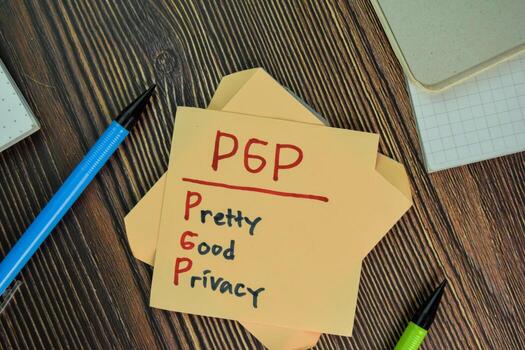 PGP - Pretty Good Privacy write on sticky notes isolated on Wooden Table. photo