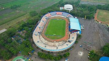 Aerial view of the Beautiful scenery of Kanjuruhan Stadium. with Malang cityscape background. Malang, Indonesia, August 26, 2022 photo