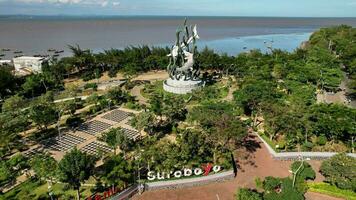 Aerial view of the A giant shark and crocodile statue as a symbol of the city of Surabaya. A landmark or monument as an icon of Surabaya city. East Java, Indonesia, August 28, 2022 photo