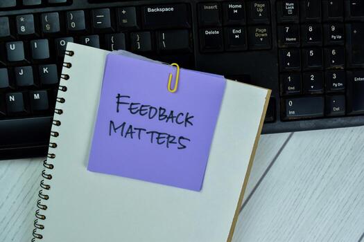 Concept of Feedback Matters write on sticky notes isolated on Wooden Table. photo