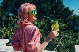 fashionable woman in green sunglasses with cocktail in summer outdoors Summer day photo