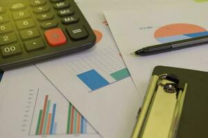 Calculator budget cost and analysis financial. Selective focus on pen. Business and finance concept of office desk photo