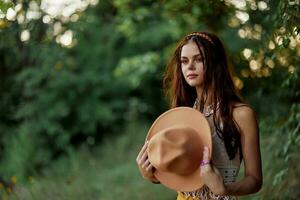 A woman dressed as a hippie with pigtails on her head travels outdoors at a campground in the fall and enjoys life photo