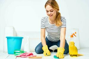 Cleaning lady sitting on the floor cleaning supplies cleaning house interior photo