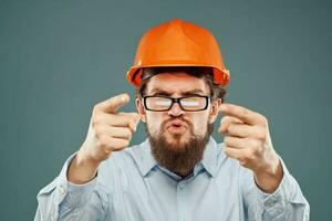 After wearing orange helmet shirt glasses hand gestures cropped view industry construction photo