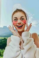 joyful woman with patches on her face against the background of nature mountains on the balcony photo