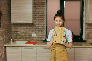 woman houses in the kitchen cutting board with knife apartments Lifestyle photo