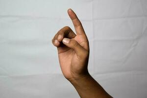 Close up Asian man shows hand gestures it means I beg Your Pardon isolated on white background photo