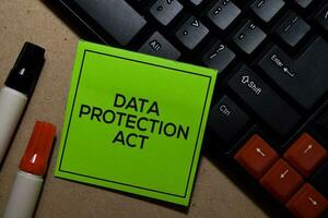 Data Protection Act write on sticky notes isolated on Office Desk photo