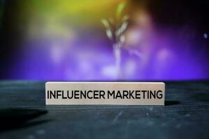 Influencer Marketing on the sticky notes with bokeh background photo