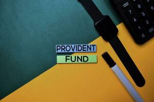 Provident Fund text on top view color table background. photo