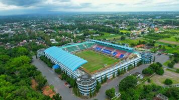 Aerial view of the Beautiful scenery of Maguwoharjo Stadium. with Sleman cityscape background. Sleman, Indonesia, December 6, 2021 photo