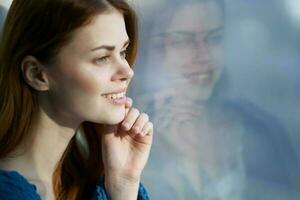 woman sitting near the window with a blue plaid rest Lifestyle photo